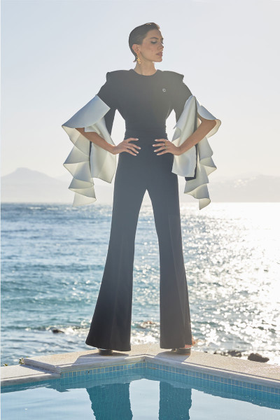Black And White Flared Jumpsuit With Padded Shoulders, Oversized, Cascading Ruffle Sleeves, Matching Tie Belt And A Wide Open Back